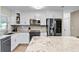 Close-up shot of a beautifully updated kitchen with stainless steel appliances and stone countertops at 456 Willowbrook Ln, Longwood, FL 32779