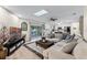 Living room with access to outdoor deck and view into modern kitchen space at 456 Willowbrook Ln, Longwood, FL 32779