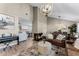 Spacious living room with fireplace, chandelier, modern furniture, and view of the dining area at 456 Willowbrook Ln, Longwood, FL 32779