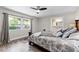 Inviting main bedroom with a ceiling fan, neutral walls, and view into the main bathroom at 456 Willowbrook Ln, Longwood, FL 32779