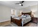 Inviting main bedroom with ceiling fan, neutral walls, and dark wood furnishings at 456 Willowbrook Ln, Longwood, FL 32779