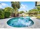 Backyard pool with mature landscaping, concrete patio, and privacy fence at 456 Willowbrook Ln, Longwood, FL 32779