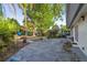 Private backyard featuring mature trees, lush landscaping, and a patio perfect for outdoor entertaining at 5547 Kingswood Dr, Orlando, FL 32810