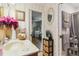 Bright bathroom featuring a marble sink, patterned wallpaper, and wood accents at 5547 Kingswood Dr, Orlando, FL 32810