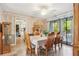 Bright dining room with a ceiling fan, a wooden table, and access to the outdoors at 5547 Kingswood Dr, Orlando, FL 32810
