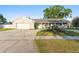 Charming single-story home with an attached garage, covered porch, and well-maintained landscaping at 5547 Kingswood Dr, Orlando, FL 32810