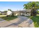 Charming single-story home with a carport and well-maintained landscaping at 5547 Kingswood Dr, Orlando, FL 32810