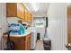 Laundry room features a washing machine, dryer, overhead cabinets, and a window at 5547 Kingswood Dr, Orlando, FL 32810