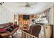 Inviting living room featuring a ceiling fan, leather sofa, and ample space at 5547 Kingswood Dr, Orlando, FL 32810