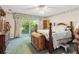 Bright main bedroom featuring a ceiling fan, garden view, and ample space at 5547 Kingswood Dr, Orlando, FL 32810