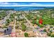 The aerial view captures the property's location within a quiet residential neighborhood near a large lake at 728 E Clifford Ave, Eustis, FL 32726