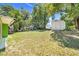 View of spacious backyard with mature trees, shed, and outdoor seating area; perfect for relaxing and entertaining at 728 E Clifford Ave, Eustis, FL 32726