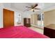 Bedroom featuring ceiling fan, natural light from a window, and a large closet at 728 E Clifford Ave, Eustis, FL 32726