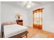 Clean bedroom featuring a window with curtains, ceiling fan, and a lamp on a bedside table at 728 E Clifford Ave, Eustis, FL 32726
