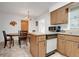 Traditional kitchen with wooden cabinets, laminate countertops, and essential appliances at 728 E Clifford Ave, Eustis, FL 32726