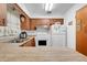 Cozy kitchen featuring laminate countertops, wooden cabinetry, and essential appliances for easy meal preparation at 728 E Clifford Ave, Eustis, FL 32726