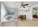 Inviting living room with a ceiling fan, with natural light coming from the large windows at 728 E Clifford Ave, Eustis, FL 32726