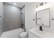 Contemporary bathroom with a gray tiled shower and a modern vanity, providing a luxurious bathing experience at 741 Marion Oaks Ln, Ocala, FL 34473