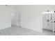 Bedroom featuring light gray flooring with view to the bathroom at 741 Marion Oaks Ln, Ocala, FL 34473