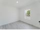 Bright bedroom with a window offering views, complemented by neutral walls and flooring for a calming ambiance at 741 Marion Oaks Ln, Ocala, FL 34473