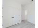Clean bedroom featuring closet doors and gray wood floors, offering storage and space for comfortable living at 741 Marion Oaks Ln, Ocala, FL 34473