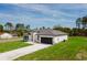 Angle shot of a modern white single-story home with black trim and a well-kept lawn at 741 Marion Oaks Ln, Ocala, FL 34473