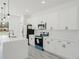 Modern kitchen features stainless appliances, white cabinets, a kitchen island, and sleek flooring at 741 Marion Oaks Ln, Ocala, FL 34473