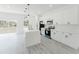 Modern kitchen with stainless appliances, white cabinets, an island, and sleek flooring at 741 Marion Oaks Ln, Ocala, FL 34473