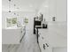 Well-lit kitchen showcasing white countertops, a sleek faucet, and modern appliances for a contemporary feel at 741 Marion Oaks Ln, Ocala, FL 34473