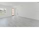 Open and bright living area showcasing sleek floors, and a natural wood door at 741 Marion Oaks Ln, Ocala, FL 34473