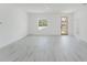 Light-filled living room features contemporary design, sleek floors, and natural wood door at 741 Marion Oaks Ln, Ocala, FL 34473