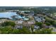 Aerial view of a property near a lake, showcasing its pool, landscaping, and a serene neighborhood setting at 789 Errol Pkwy, Apopka, FL 32712