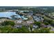 Aerial view of a property near a lake, showcasing its position on a lot in a well-maintained neighborhood at 789 Errol Pkwy, Apopka, FL 32712