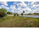 Large backyard with mature trees and a white vinyl fence, offering privacy at 789 Errol Pkwy, Apopka, FL 32712