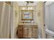 The bathroom features granite countertops, a wooden vanity, a framed mirror and tile floors at 789 Errol Pkwy, Apopka, FL 32712