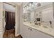 Bright bathroom vanity featuring ample storage, decorative light fixture, and well-lit mirror at 789 Errol Pkwy, Apopka, FL 32712