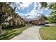 Brick home with well-manicured lawn, long driveway, and inviting landscaping at 789 Errol Pkwy, Apopka, FL 32712