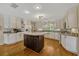 Kitchen featuring a center island, white cabinets, and stainless steel appliances at 789 Errol Pkwy, Apopka, FL 32712
