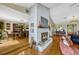 Living room view showcasing a white brick fireplace and light-filled dining area at 789 Errol Pkwy, Apopka, FL 32712
