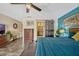 Bright bedroom features modern decor, a king bed, tile floors, a ceiling fan, and a barn door to the ensuite bathroom at 789 Errol Pkwy, Apopka, FL 32712