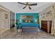 Bright bedroom features modern décor, a king bed, tile floors, a ceiling fan and barn door to the ensuite bathroom at 789 Errol Pkwy, Apopka, FL 32712