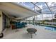 Covered patio featuring an in-ground pool with water views, comfortable seating, and a ceiling fan at 789 Errol Pkwy, Apopka, FL 32712