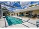 The screened-in pool with a hot tub has ample space and outdoor lounging possibilities at 789 Errol Pkwy, Apopka, FL 32712