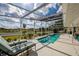 Relaxing screened-in pool and patio with lounge chairs and sunny sky at 789 Errol Pkwy, Apopka, FL 32712