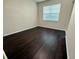 Bedroom featuring dark hardwood flooring and a bright window letting in natural light at 8271 Maritime Flag St # 125, Windermere, FL 34786