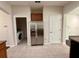 Kitchen featuring stainless steel appliances, laundry room, and door at 8271 Maritime Flag St # 125, Windermere, FL 34786
