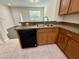 Well-lit kitchen with modern cabinets and a stainless-steel sink under the window at 8271 Maritime Flag St # 125, Windermere, FL 34786