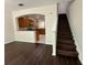 Open-concept living room with dark wood floors leading into kitchen with stainless appliances at 8271 Maritime Flag St # 125, Windermere, FL 34786