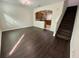Inviting living area with wood floors, adjacent to a kitchen, and staircase to upstairs at 8271 Maritime Flag St # 125, Windermere, FL 34786