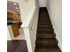 Dark wood staircase leading to the upper level, open to the kitchen at 8271 Maritime Flag St # 125, Windermere, FL 34786